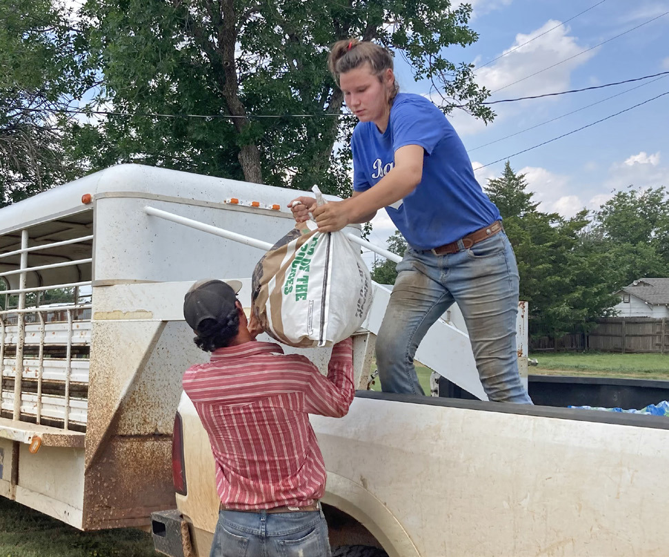 HELPING HAND Volunteers loaded supplies at the school bus barn in Matador, which served as a distribution point for aid and. LIZ ADAMS PHOTO