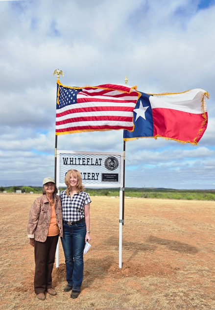 WINDY DAY AT WHITEFLAT Marisue Potts Etheredge (left) and Leesa Ruderman led efforts to secure a Texas Historical Commission historic cemetery medallion. It was installed by Motley County Historical Commission volunteers and dedicated April 11. | COURTESY PHOTO