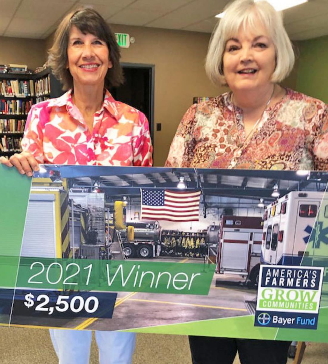 PUTTING MONEY WHERE THEIR MOUTHS ARE Laura Long, president of the library board, and Cathey Weaks, vice president of the library board, accepted a $2,500 grant on the Silverton Public Library’s behalf. Gary and Cathey Weaks nominated the library for the Bayer America's Farmers Grow Communities grant. | COURTESY PHOTO