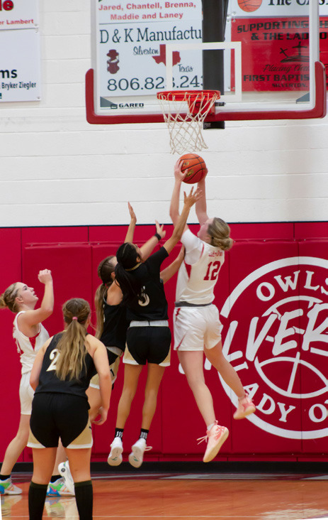 MADDIE FRANCIS CLAIMS A REBOUND under a Lady Tiger goal Friday night in Silverton.