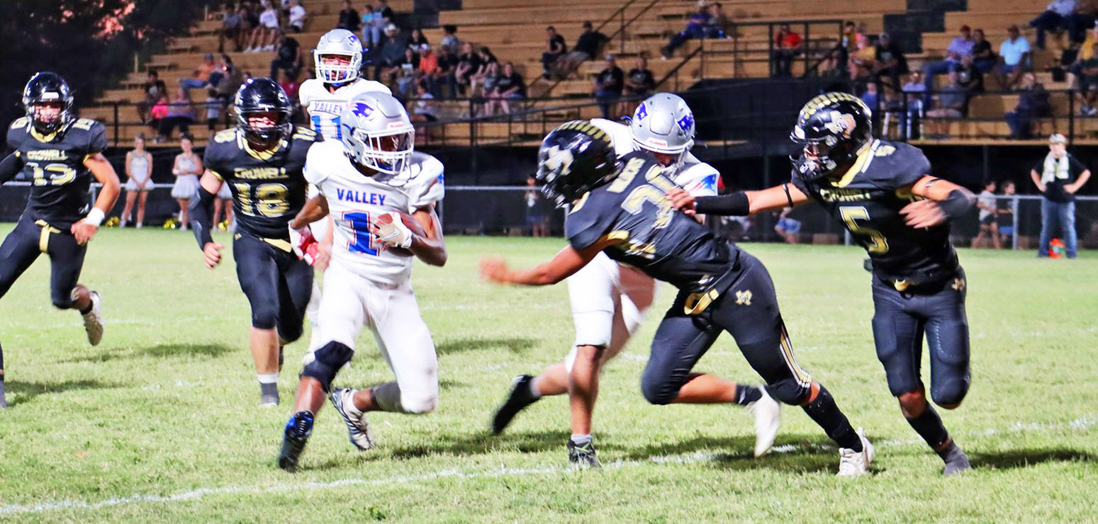 ESCAPING WILDCATS Valley junior Taevion Ramos, #1, finds daylight when surrounded by Crowell defenders. The Patriots lost a heartbreaker to the Wildcats 62–61 on the road Friday night. | SHADI BUCHANAN PHOTO