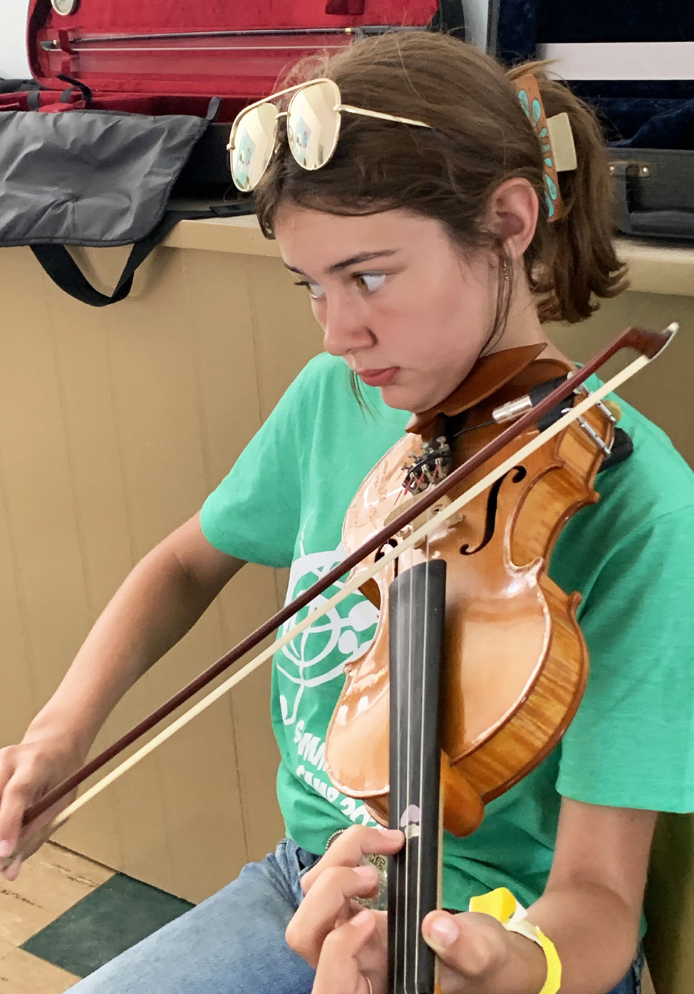 YOUNG FIDDLER Romie Hinshaw practices her bow technique at the annual BAM Music Camp in Turkey this week. | HANABA MUNNWELCH