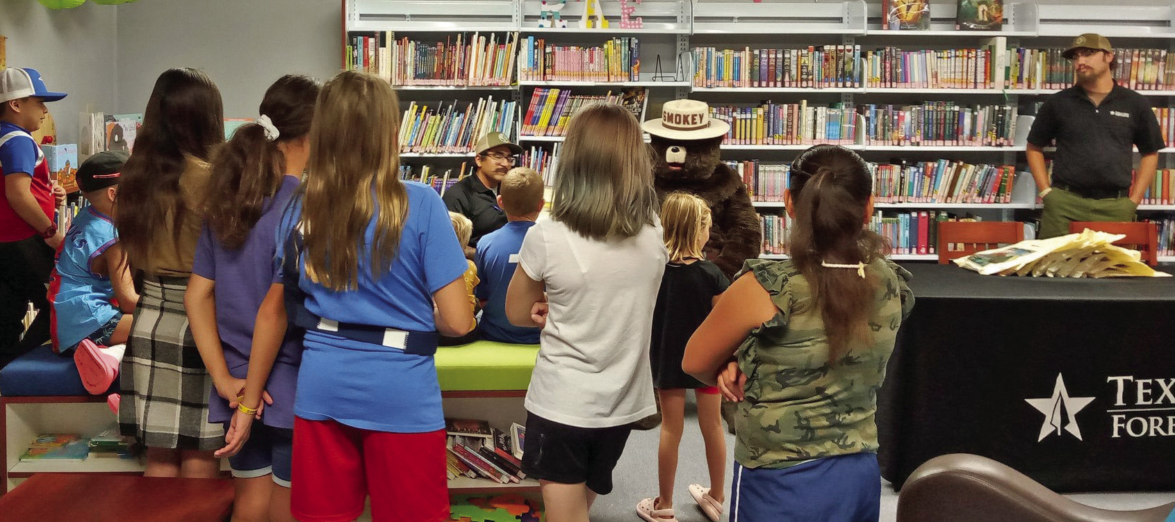 Texas A&M Forest Service and Smoky the Bear visited with youngsters at the Caprock Library in Quitaque earlier this month for their summer reading program. | COURTESY PHOTOS