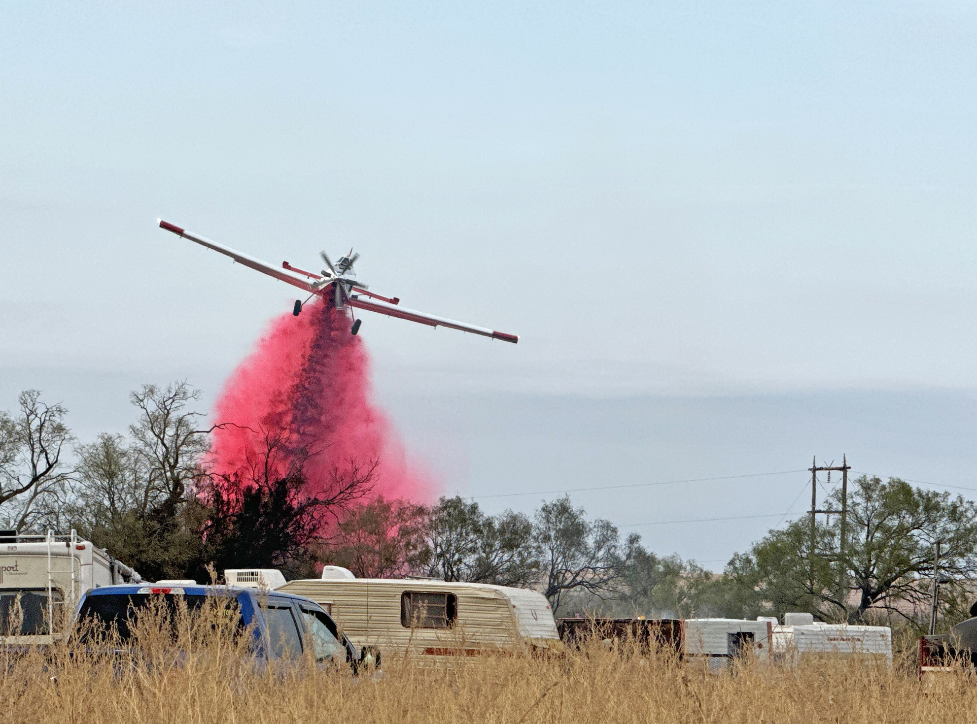FIREFIGHTING FROM GROUND AND AIR A Texas A&amp;M Forest Service plane dropped retardant along the northeast fire line of last Friday’s hunting camp fire outside Turkey, Texas. MORE PHOTOS, PAGE 10 | KODIE FAIRCHILD