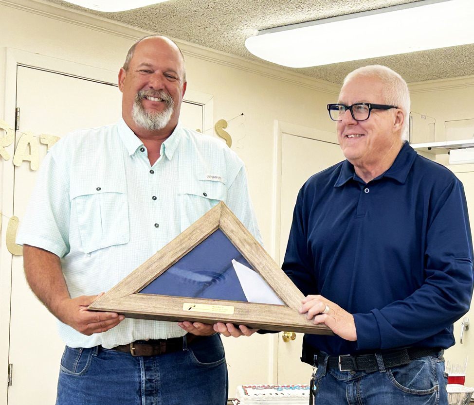 COTTLE RETIREMENT Last week marked the end of Ron Gilbert’s 26-plus-year career with theTexas Department ofTransportation, with has last 15 years spent as the Cottle County maintenance supervior. He was presented a Texas flag by District Engineer Darwin Lankford. | TxDOT PHOTO
