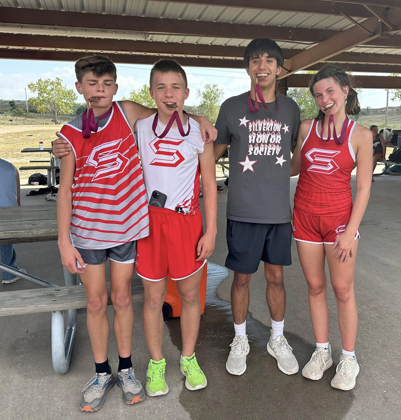 GREENBELT MEDALISTS Four Silverton Owls (from left), Corbin Hall, Briggs Holt, Haygen Lopez and Melody Rampley, placed in the top ten, earning medals at the Clarendon Lake Greenbelt Run cross country meet on Tuesday, Sept. 16. | COURTESY PHOTO