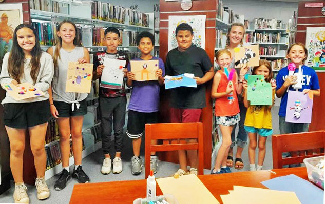 EXTENSION AGENT STEPHANIE OTIS (back right) was invited to lead a Summer Reading Program at Caprock Public Library during which the youngsters created food art. | COURTESY PHOTO