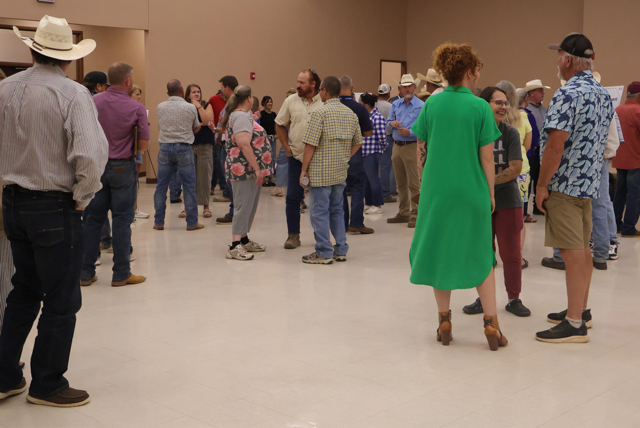 A FAIR SHAKE AT NEW CAREERS Community members gather and converse during the QTS job fair held at Valley School in Turkey.