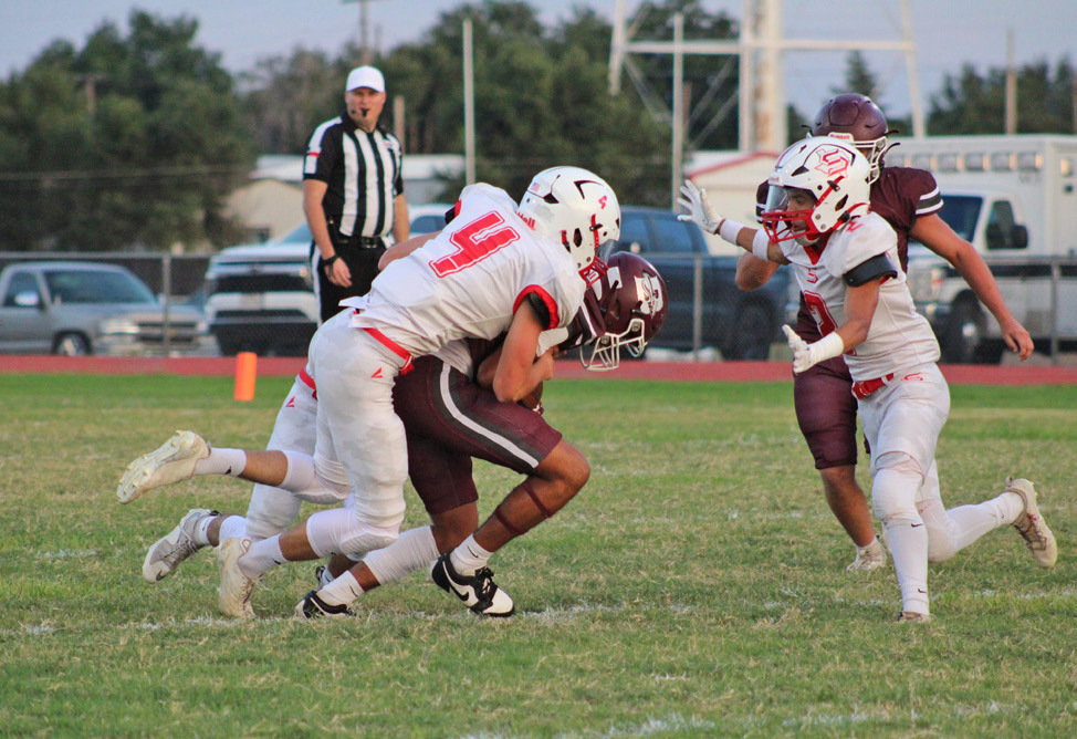 OWLDEFENSIVEFLOCK OwlCooperMullinsbringsdownaBooker Kiowa with the help of two team mates, Lucas Holt and Haygen Lopez on Thursday night, Sept. 18. | COURTESY PHOTO