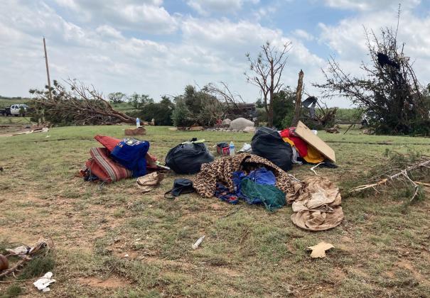 Clothing was gathered from the surrounding area and piled near a home destroyed by Tuesday’s tornado.