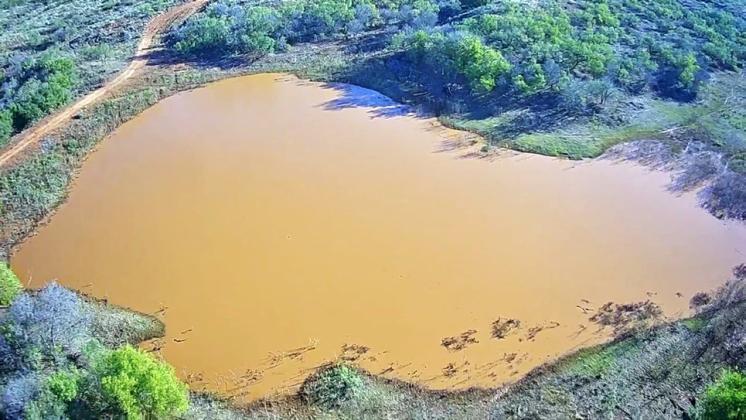ONCE-EMPTY WATER TANK NOW FULL after an additional 3.73 inches fell over a Hall County ranch.