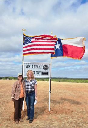 WINDY DAY AT WHITEFLAT Marisue Potts Etheredge (left) and Leesa Ruderman led efforts to secure a Texas Historical Commission historic cemetery medallion. It was installed by Motley County Historical Commission volunteers and dedicated April 11. | COURTESY PHOTO
