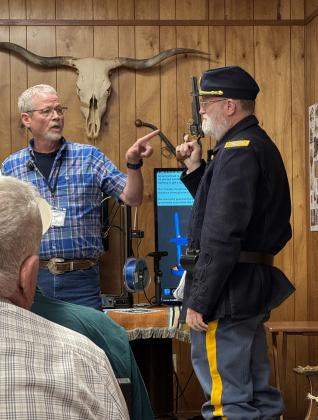 INVESTIGATORTODD SMITH (left) isn’t presuming to give orders to reenactor T. G. Caraway during last Saturday’s Comanchero Rendezvous program—he’s demonstrating the dress and armament of a U.S. army soldier circa 1871, the key focus of his recent archeological explorations. MORE PHOTOS, PAGE 5 | CAPROCK COURIER
