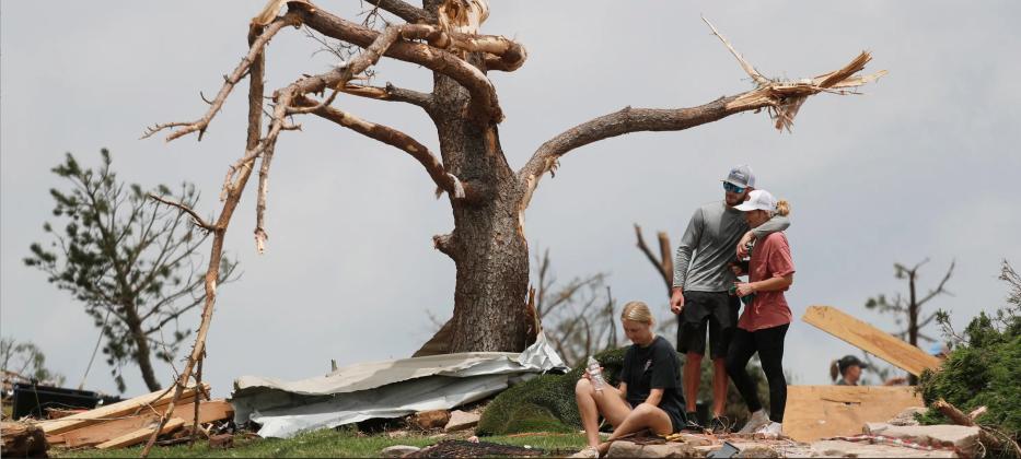 MARSHALINGSTRENGTH From left:Tyne Marshall sits on the ground next to Brett Homer and Cambrie Marshall, granddaughters of Ken and Mary Marshall, who survived the tornado that struck the small town of Matador on June 21, 2023. | MARK ROGERS FOR THE TEXAS TRIBUNE
