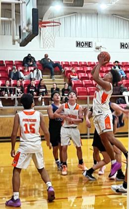DRAGONS WIN Paducah junior Darren Mackey scored from the paint in the Dragons’ 78-56 win over Winters in the AspermontTournamentDecember12,with Nico Zapata (15) and Caler Timmons (11) looking on. | CAPROCK COURIER