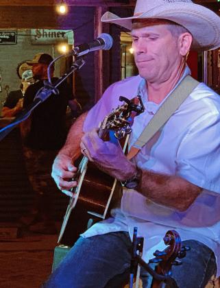 TURKEY STAR Leader of Bob Wills’ Texas Playboys Jason Roberts, dressed casually in contrast to his Bob Wills Day duds, exchanged fiddle for guitar Saturday night at Turkey’s third annual Songwriter Festival.