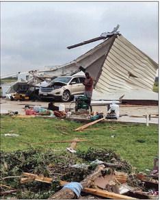 AMONG MANGLED METAL ROOFS and crushed vehicles, Matador residents figured out solutions for basic needs—and many volunteers came to help as well. | PHOTO PROVIDED BY CODY COOPER