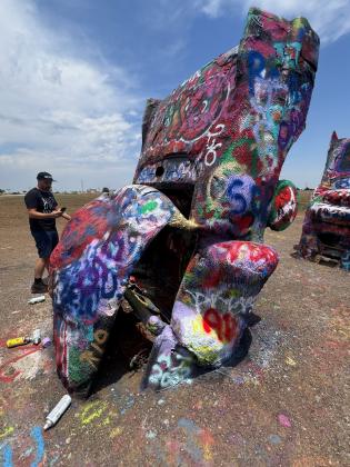 CARS OR CARCASSES? At the Cadillac Ranch today, decades of accretions of spray paint seem to have melted the Caddies’ forms acrylic flowstone, rendering them hardly recognizable as automobiles.