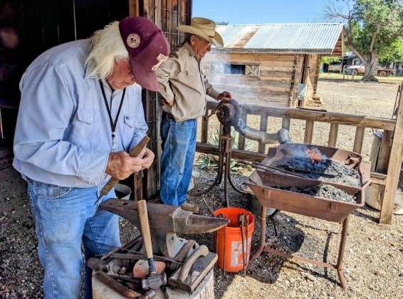 TECHNIQUES FROM TIMES PAST On Saturday at the Comanchero Rendezvous, Comanchero Canyons Mseum directors Rusty Etheredge, left, and Cotton Elliot gave demonstrations at the blacksmith shop. MORE PHOTOS, PAGE 8 | KAYLA WHITE PHOTO