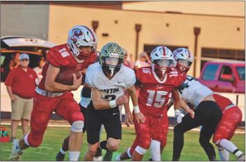SILVERTON SHUT OUT The swarming Jayton defense shut down much of the rushing game of the Silverton Owls inThursday night’s 46-0 shut-out by the Jaybirds. Senior Sawyer Francis, #16, attempts to get some offense going. | AMANDA MCGEE PHOTO