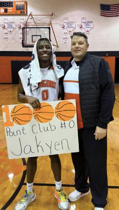Jakyen Wright with the Paducah Dragons boys varsity basketball team exceeded the 1,000-point milestone last week in the Dragons’ 57-32 district win over Patton Springs. Coach Eric Rekieta (right) congratulates Wright on his accomplishment. | COURTESY PHOTO