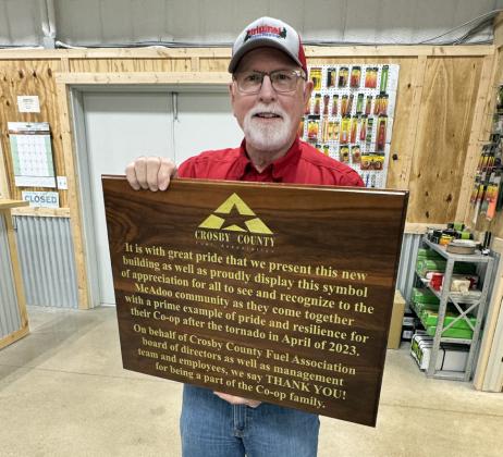 STEVE RILEY, general manager of CCFA, shows off the plaque made by Larry Wood of Idalou that will be mounted on the McAdoo store's wall.