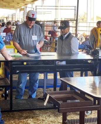 MAKING THE GRADE Steven Uribe received feedback on his project at the San Angelo Ag Mech Show.