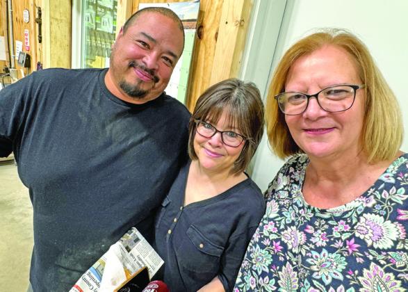 SMILING FACES of Crosby County Fuels staffers Luis Guzman, McAdoo manager, and Chris Hunt and Freda Hitt of the home office in Ralls.