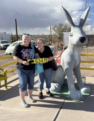 HEREWEARE Kay and Barbara with our own sign to remind us the distance from back home to the Jack Rabbit. | COURTESY PHOTO
