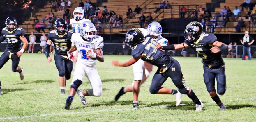 ESCAPING WILDCATS Valley junior Taevion Ramos, #1, finds daylight when surrounded by Crowell defenders. The Patriots lost a heartbreaker to the Wildcats 62–61 on the road Friday night. | SHADI BUCHANAN PHOTO