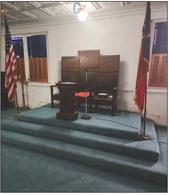 INTERIOR OF THE LODGE features and a vintage lamp decorated in Masonic emblems.