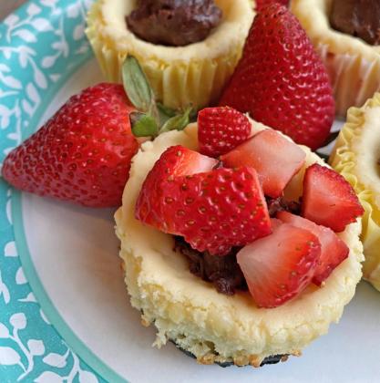 CHOCOLATE AND CHEESECAKE A dollop of chocolate ganache before topping with strawberries gives this batch of muffins a “chocolate-covered-strawberry” effect. | ANGELINA LARUE