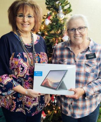GRAND PRIZE Paducah Chamber of Commerce president Delisa Piper (left) presents Lesa Saltzman of the Triangle Ranch with the grand prize, a Microsoft Surface Pro, in the Paducah Chamber of Commerce 25 Days of Christmas. | COURTESY PHOTO