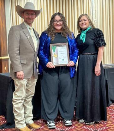 GOLD STAR Makenlee Lemons of Quitaque (at center between 4-H presenters Josh Brooks andTina Bryant) has earned 4-H’s Gold Star award. | COURTESY PHOTOS