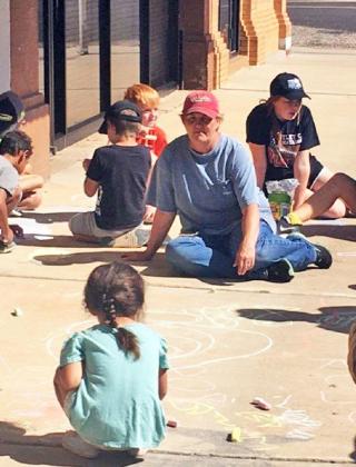 SIDEWALK FUN The Motley County Library kicked off its “Oceans of Possibilities” summer reading program this week with a fun sidewalk art project. | COURTESY PHOTOS