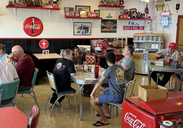 BRENDA AND BRENNEN talk turkey about Route 66 travel at her Midpoint Café in Adrian, Texas. | THE TEXAS SPUR
