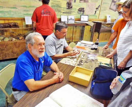 ARCHEOLOGISTS, HISTORIANS TO GATHER Paul Katz and Rick Day evaluate collections brought in for identification and analysis at a previous gathering at Comanchero Canyons Museum in Quitaque. | KAYLA WHITE PHOTO