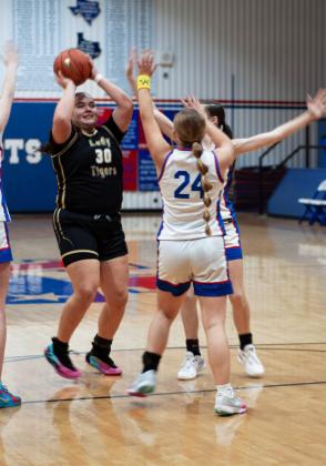 EMBERLYNN MULLIN stops a McLean Lady Tiger in Friday night’s game at home, securing a Lady Patriot 73-27 victory. | DEY LANE