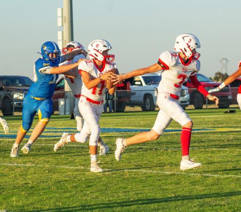 HANDOFF COMPLETE Quarterback Cayden Smith makes the handoff to Lucas Holt. | KODIE FAIRCHILD