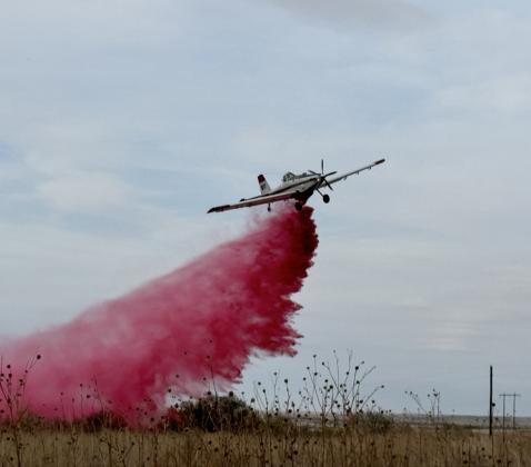 Texas A&amp;amp;M Forest Service drops retardant along Northwest fire line.