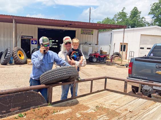 James McKleskey and Rusty Etheredge changed a trailer tire in Roaring Springs so they could return to Matador to help families clean up.