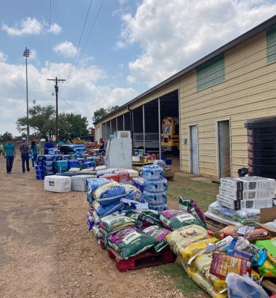 Lance Logsdon of Dickens helped organize donated supplies as they arrived at the school bus barn.