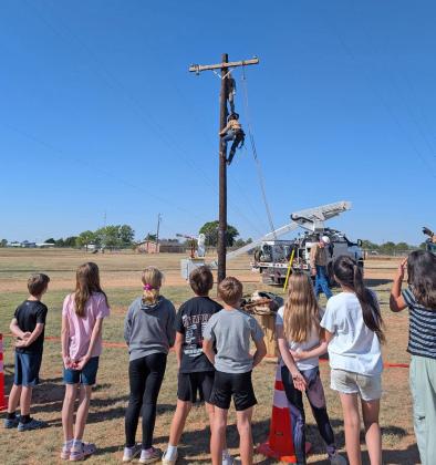 POLE CLIMBING &amp;amp; RESCUE The Motley County fourth grade class learned about those who climb power poles and how they rescue other climbers in an emergency during a field trip to South Plains Electric Cooperative for Safety Day. | COURTESY PHOTO