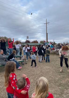 EXCITEMENT BUZZED ALOFT as LifeStar 4 approached over the crowd for a landing to deliver Santa and Mrs. Claus to Christmas in the Valley in Turkey.