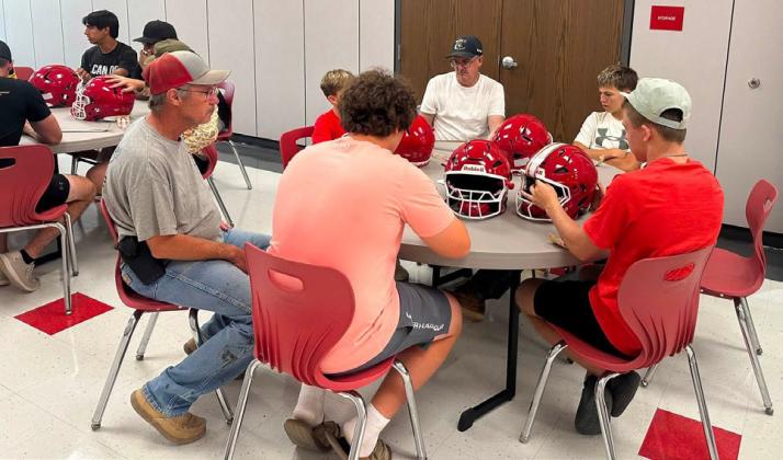 DECALS WITH DADS The Silverton Owls continued an annual tradition last week, Decals with Dads, as fathers and sons came together to get the team’s helmets ready for the new season. | COURTESY PHOTOS