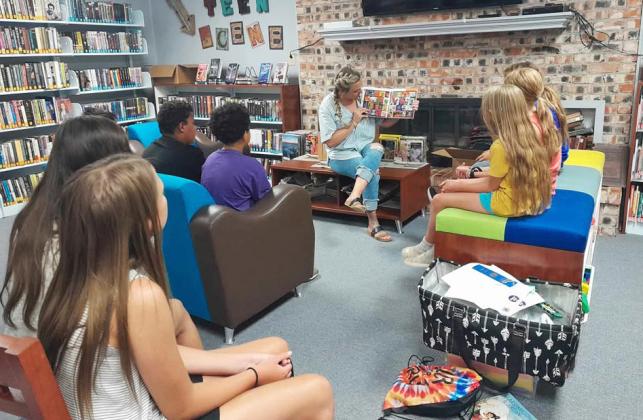 CAPROCK SUMMER READING At last week’s Summer Reading Program at the Caprock Public Library in Quitaque, Stephanie Otis read “The Scrap Book” by Lois Elhert and the kids learned about how she came up with her art. After the book, the children made their own craft out of scraps. | COURTESY PHOTOS