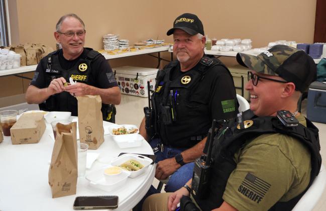 LOCAL LAW ENFORCEMENT personnel shared a moment over dinner during the QTS job fair. The Hall County Sheriff’s Office will doubtless be a key player in public safety for the region as the Lancium project progresses.