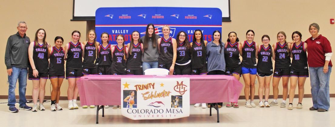 VALLEY 2024-25 BASKETBALL TEAM stood with Schlueter after she signed her letter of intent with CMU. | COURTESY PHOTO
