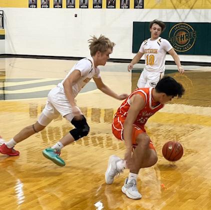 PICKPOCKET Jaguar Junior Kaleb Green picks the pocket of a Rotan player in Saturday’s win over the Yellowhammers.