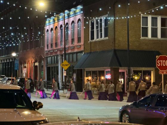 SURREAL SCENE in predawn downtown Springfield, Missouri, April 30 is really nothing more than the Southwest Missouri State flag corps proceeding to their lineup point for the filming of an NBC-TV“Today Show Third Hour Live”segment on the birthplace of Route 66.